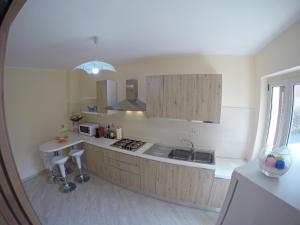 a kitchen with a sink and a stove top oven at BB Aretè in Scilla