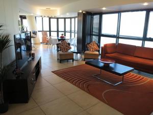 a living room with a couch and a table at Beautiful Ocean Views in Strand