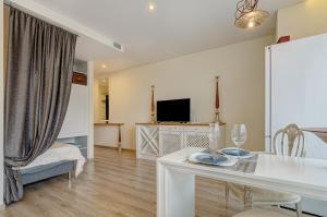 a living room with a white table and chairs at Bright apartment near Akropolis in Vilnius