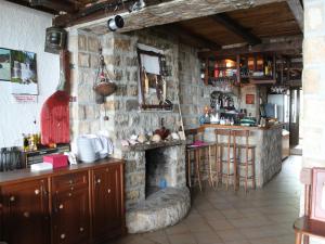 a kitchen with a stone fireplace in a room at Apartments Galija in Petrovac na Moru