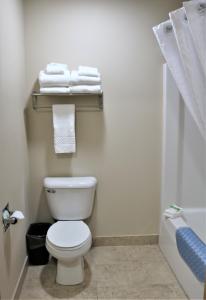 a bathroom with a white toilet and towels at Rock Island Inn & Suites in Atlantic