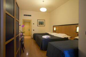 Posteľ alebo postele v izbe v ubytovaní Hotel Masini