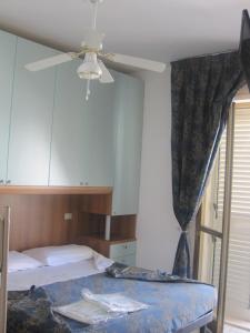 a bedroom with a bed and a ceiling fan at Verde Mare in Silvi Marina