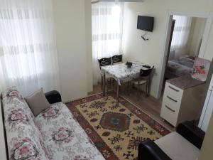 a living room with a couch and a table at Cerit Pansiyon in Gokceada Town