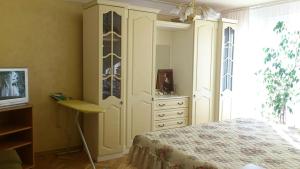 a bedroom with a bed and a dresser with a dresser at Апартамент Граф Игнатиев in Varna City