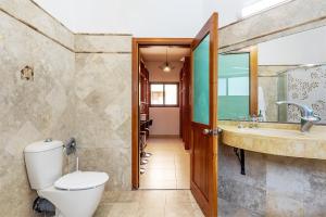 a bathroom with a toilet and a sink at Desert Gat in Qiryat Gat +39 photos