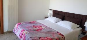 a bedroom with a large bed with flowers on it at Lodge Rosa in Agropoli