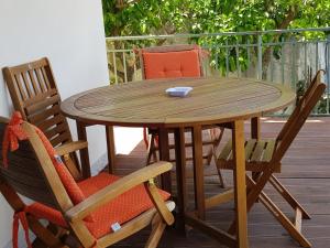 a wooden table and chairs on a deck at Lodge Rosa in Agropoli