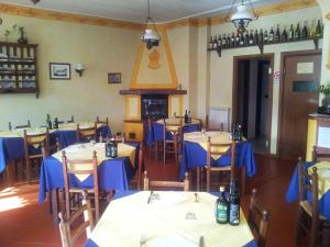 comedor con mesas y sillas y chimenea en Agriturismo Bell'Aria, en Uscio