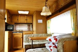 a kitchen with a couch and a table in a room at Camping Pod Żaglem in Mielno