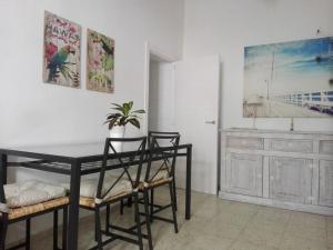 a dining room with a black table and chairs at Ave Maria 2 in Tarifa