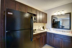 a kitchen with a stainless steel refrigerator and a sink at North Platte Inn and Suites in North Platte