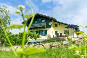 a house with an umbrella on top of a hill at Das Weinberghaus in Ratsch an der Weinstraße