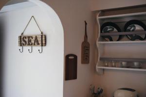 a kitchen with a shelf with a sign that reads zeal at Fotinos House Skiathos in Skiathos +27 photos
