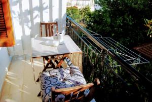 a balcony with a table and chairs on a balcony at Fotinos House Skiathos in Skiathos