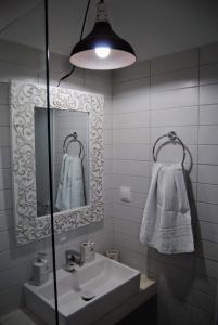 a bathroom with a sink and a mirror at Fotinos House Skiathos in Skiathos