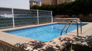 a swimming pool with a fence around it at Apartamentos Gandía Centro 3000 in Gandía