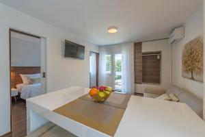 a living room with a table with a bowl of fruit at Up27 Suites Plitvice in Plitvička Jezera