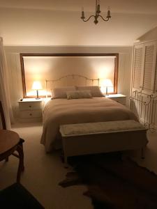 a bedroom with a large bed with two lamps on it at McIvor Lodge in Invercargill