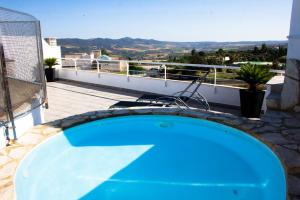 a blue swimming pool on the roof of a house at Puerta De Ronda in Ronda