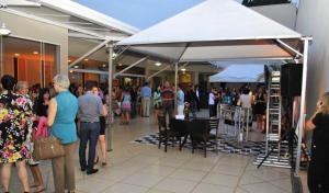 a group of people standing in a shopping mall at Lazuli Hotel in Itatiba