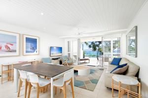 a living room with a table and a couch at Fairshore Apartment 15, Noosa Heads in Noosa Heads