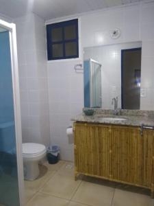 a bathroom with a sink and a toilet in it at Eco suites Caravelas in Cabo Frio