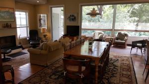 a living room with a table and chairs and a couch at Glenburn House in OʼConnell