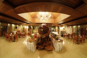 a large carving of a bear in the middle of a restaurant at KMA NAYPYITAW Hotel in Nay Pyi Taw