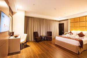 Krevet ili kreveti u jedinici u okviru objekta Tara Hotel Yogyakarta