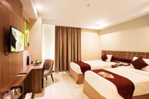 Krevet ili kreveti u jedinici u okviru objekta Tara Hotel Yogyakarta