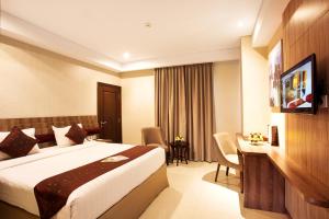 Krevet ili kreveti u jedinici u okviru objekta Tara Hotel Yogyakarta