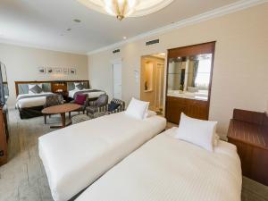 Postel nebo postele na pokoji v ubytování HOTEL MYSTAYS Sapporo Aspen