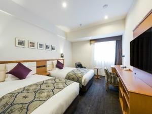 Postel nebo postele na pokoji v ubytování HOTEL MYSTAYS Sapporo Aspen