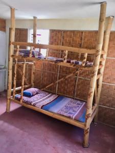 a set of three bunk beds in a room at SunnySide bed & bar in Siquijor
