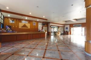 a large lobby with a bar in the middle at Surin Majestic Hotel in Surin