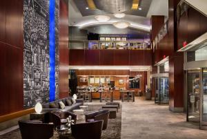 a lobby of a hotel with couches and chairs at Hyatt Regency Vancouver in Vancouver