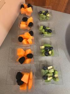 a bunch of fruit in plastic containers on a table at Hotel Ragno D'Oro in Sottomarina