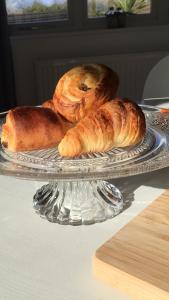 two loaves of bread on a glass plate on a table at Little Owl Barn in Marlborough