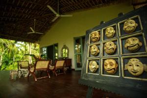 a room with a bunch of masks on the wall at Ginganga Lodge in Galle