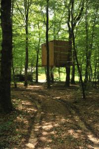 a wooden sign in the middle of a forest at Cabanes Espace Fouletot in Mont-sous-Vaudrey