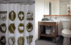 a bathroom with a toilet and a shower curtain at Basecamp Tahoe South in South Lake Tahoe