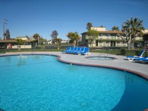 a swimming pool with blue lounge chairs in a resort at Town House Motel in Lancaster