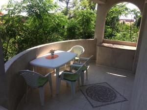 a patio with a table and chairs on a patio at Apartments MiaMaja in Novalja