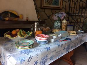 a table with a blue and white table cloth with food on it at Reginella in Cetara
