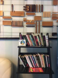 a shelf full of books on a wall at HOTEL T23 srl in Iaşi