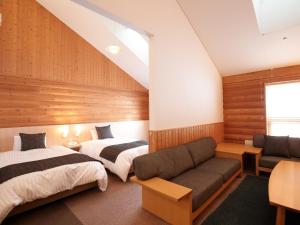 Letto o letti in una camera di Log Hotel The Maple Lodge