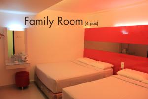 a room with two beds and a family room sign at Time Hotel in Kuala Lumpur