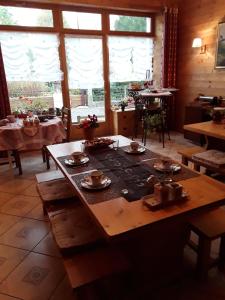 a dining room with a table with dishes on it at Le Bellevue in Giron