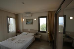Postel nebo postele na pokoji v ubytování Aria Doria Otel